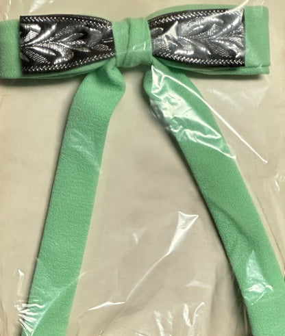 The Colonel Ties from Square Up Fashions adds a touch of southern charm with its mint green fabric bow accented by silver leaf-patterned highlights in the center, all presented in clear plastic packaging.