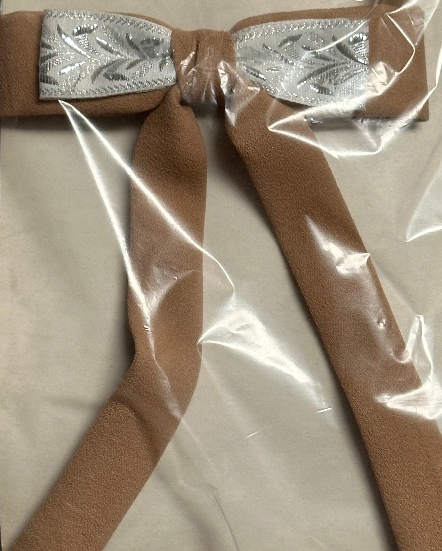 Colonel Ties, by Square Up Fashions, features a tan bow with an elegantly embroidered silver center that captures a sophisticated western style, meticulously packaged in clear plastic wrap.