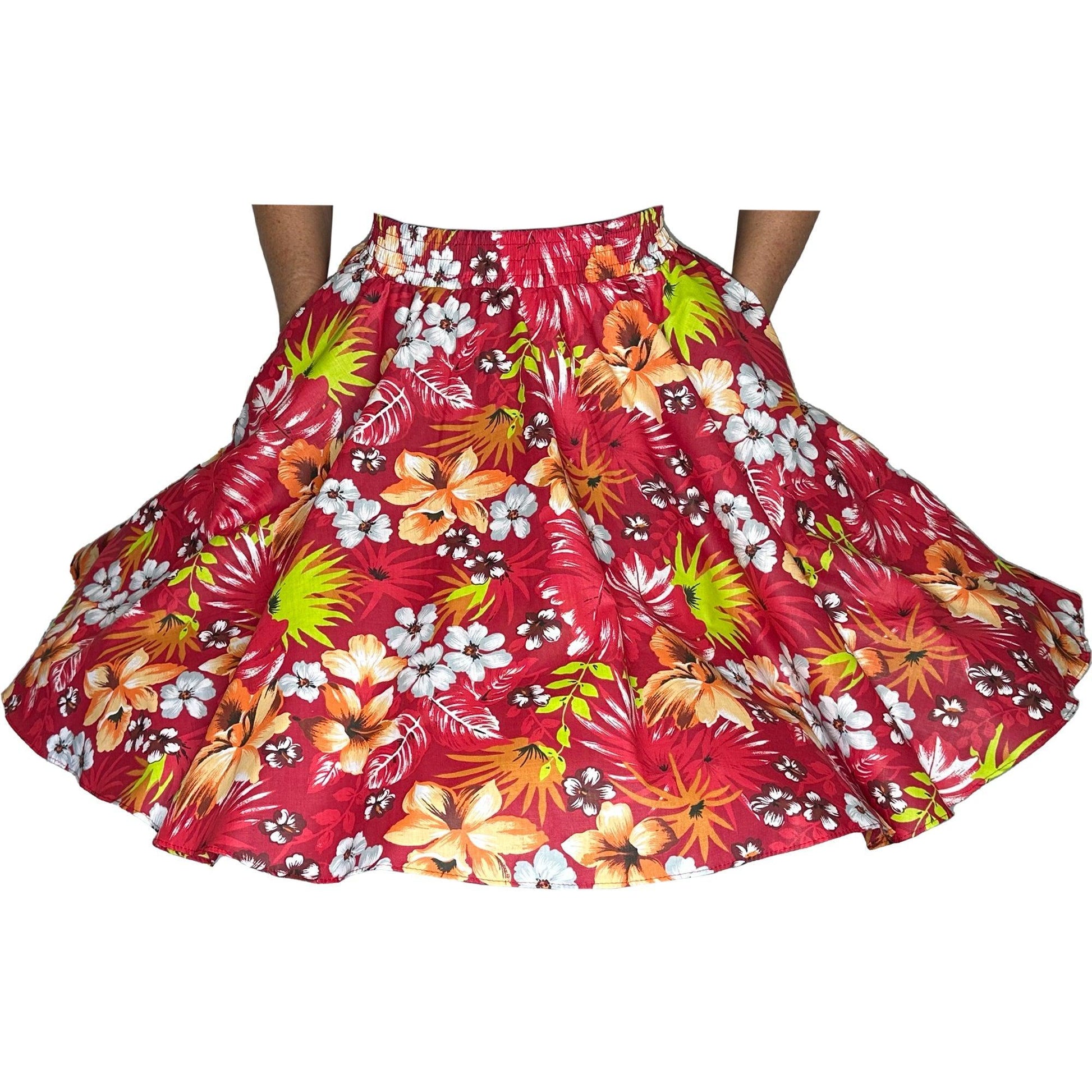 A woman wearing a Tropical Hawaiian Square Dance Skirt by Square Up Fashions adorned with hibiscus flowers.