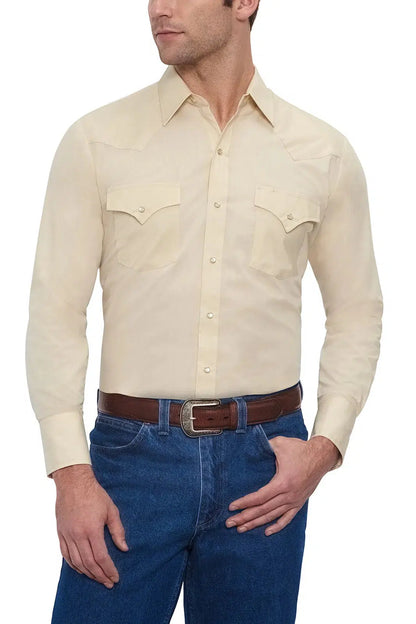 A man wearing an ELY Men's Long Sleeve Solid Western Snap Solid Shirt with Western Yokes and jeans.